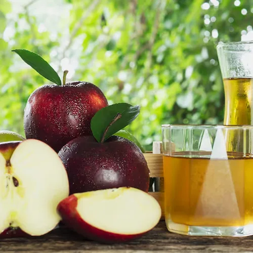 Apples and a glass of apple cider vinegar